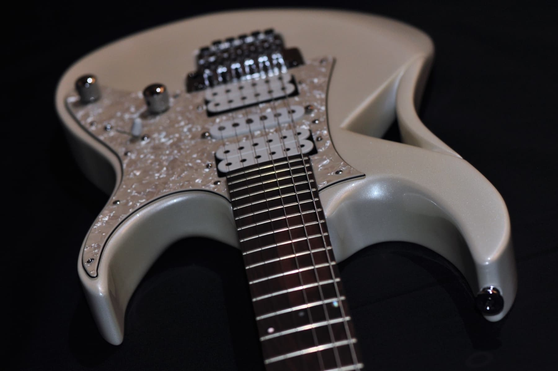 The front of the guitar with its mother-of-pearl pickguard