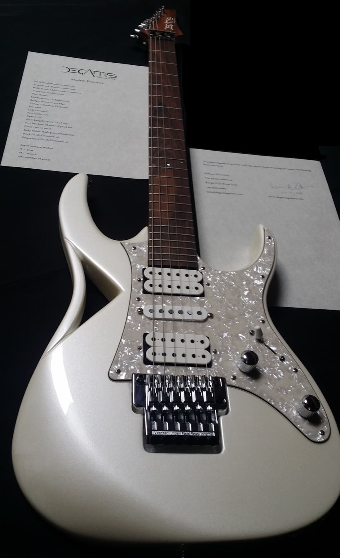 The guitar next to its signed spec sheet