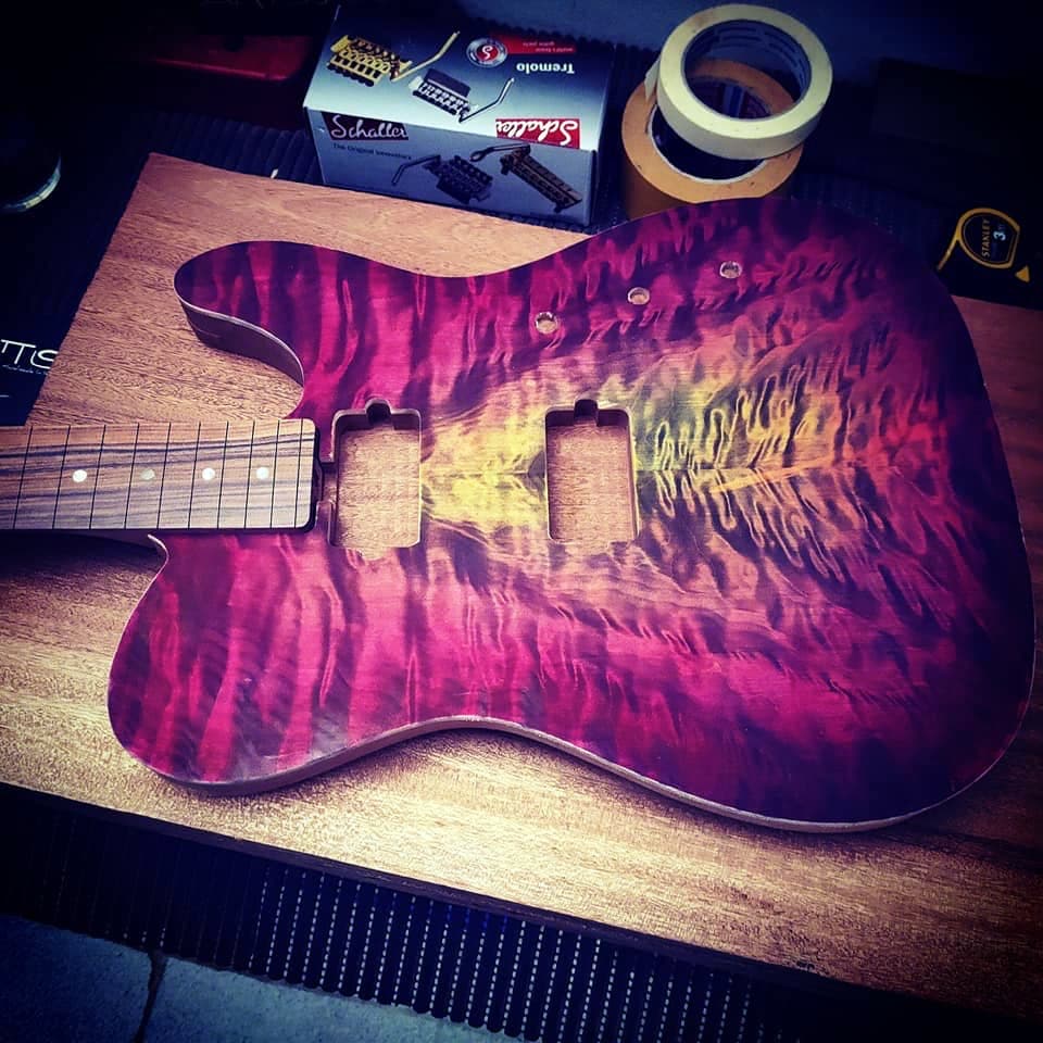 A figured maple board glued to the body, next to the neck with its fretboard